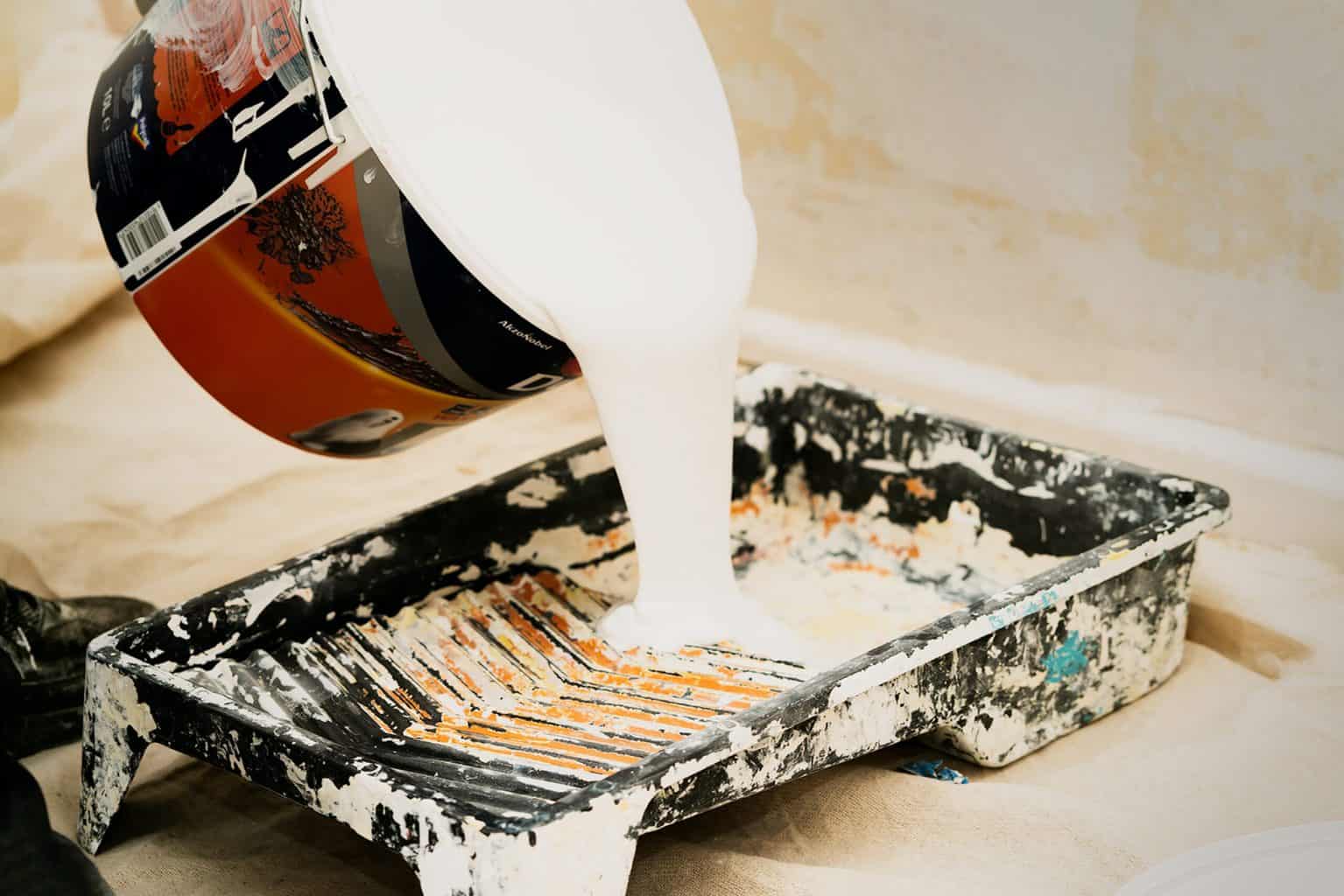 Pouring a paint on a pan