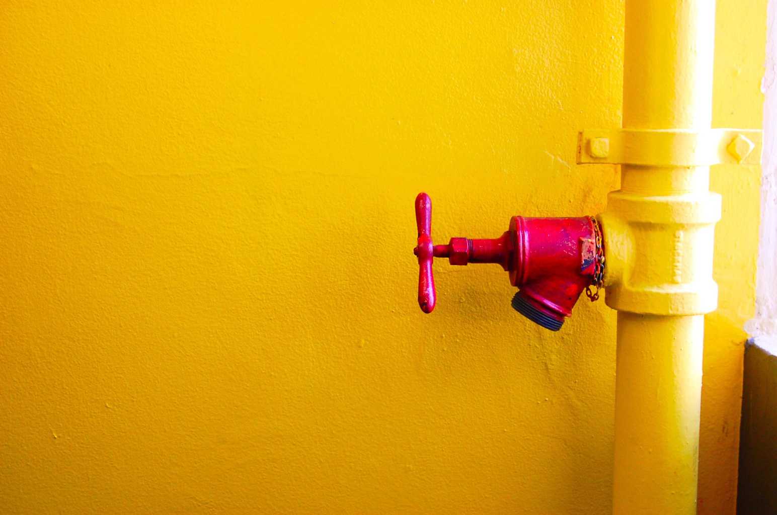 A wter shut off valve with yellow background