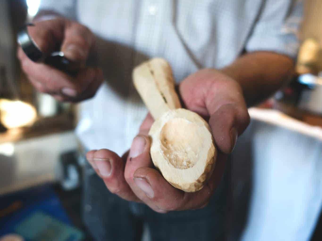 A wooden carving of a small spoon