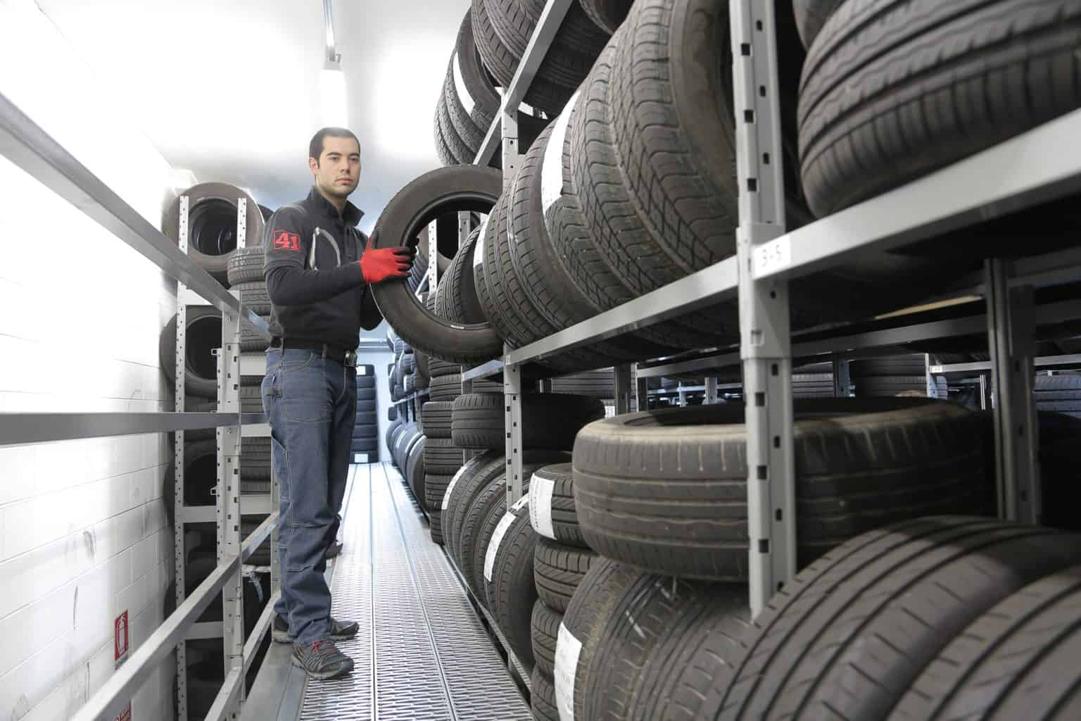 A man with a rack of tires