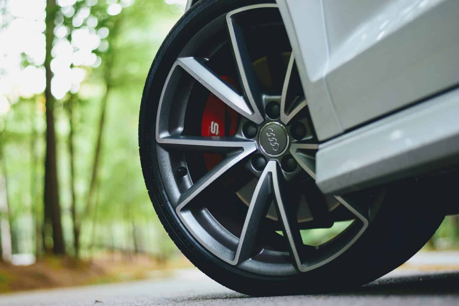 A close up shot of a tire of a gray car