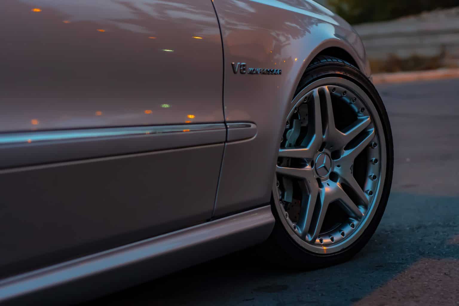 A gray car with a shiny tire