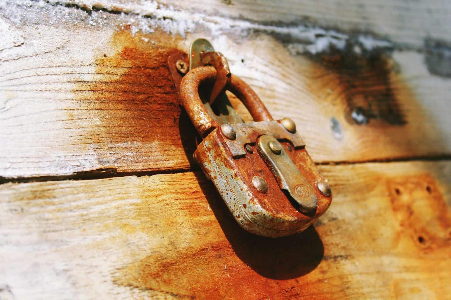 A rusty lock of a rust stained wooden box