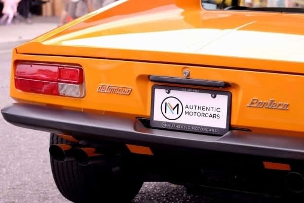 Rear view of an orange vintage car