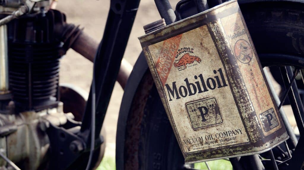 An old motor oil beside a motor wheel