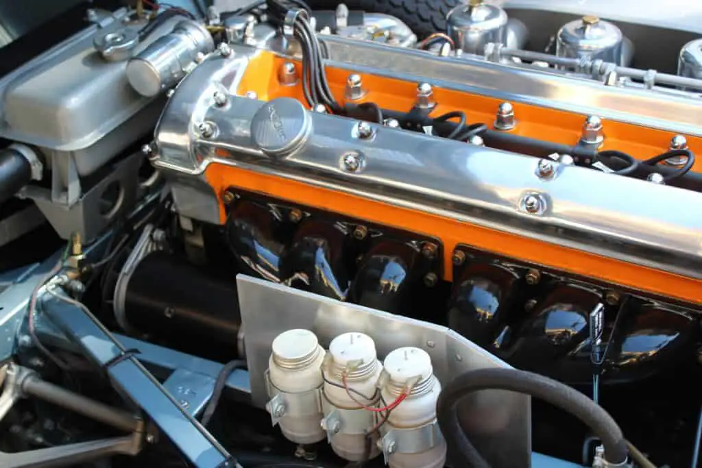 An orange toned and chrome finished car engine