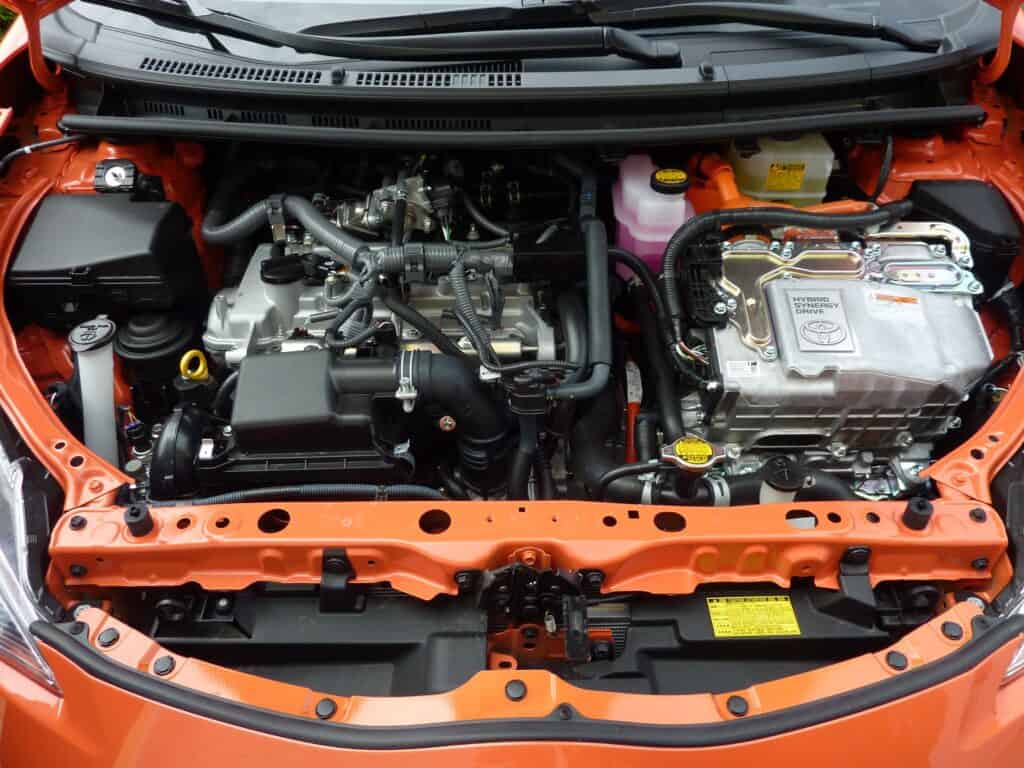 A car engine of an orange toned car