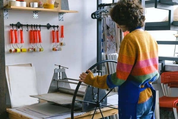 A person using a tool used to etch on metal