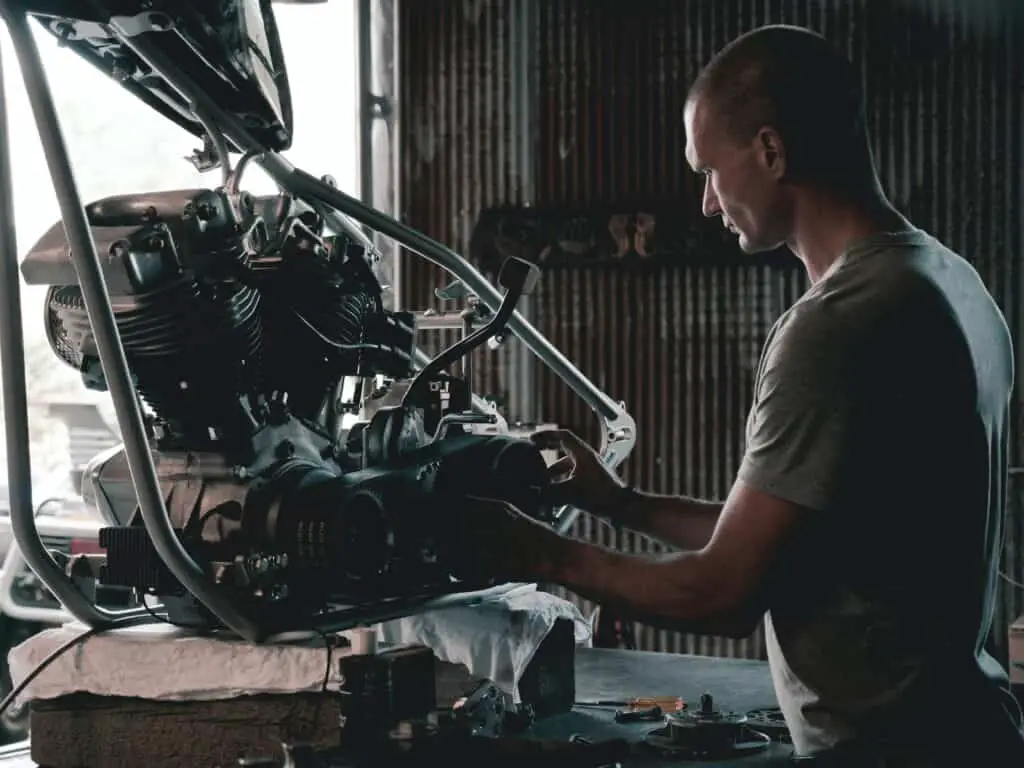 A mechanic handling a motor engine