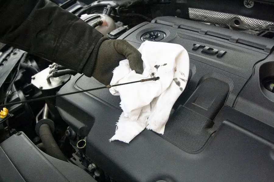 Person changing a car engine's oil
