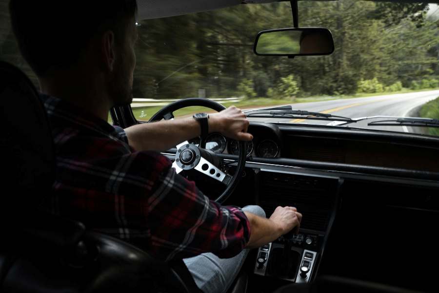 Person driving his car on an open road