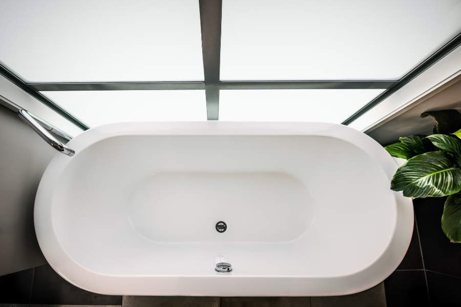 Top down view of an oval ceramic bathtub